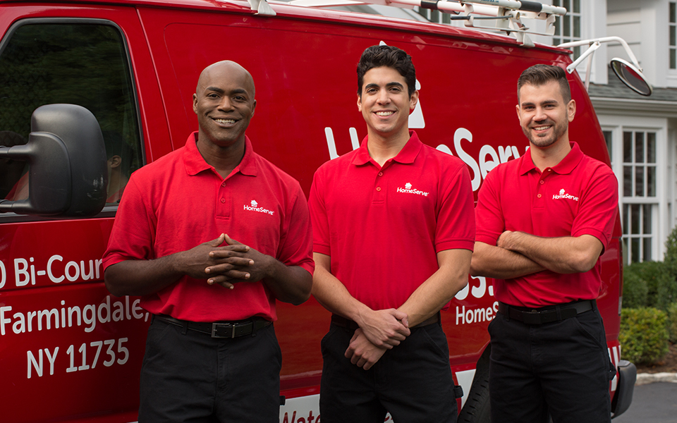 3 people in front of a Homeserve van